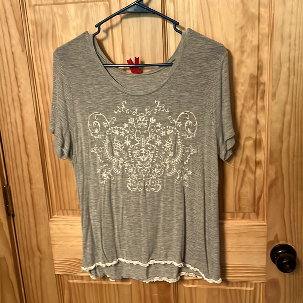 Red Carmel detailed grey top.